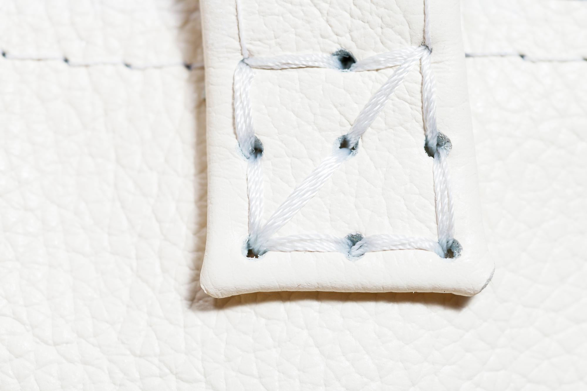 hand stitching detail with natural threads