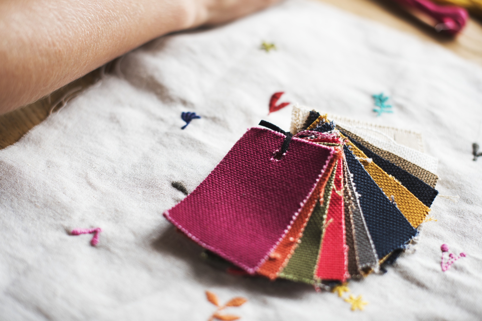 collection of embroidered samples on table